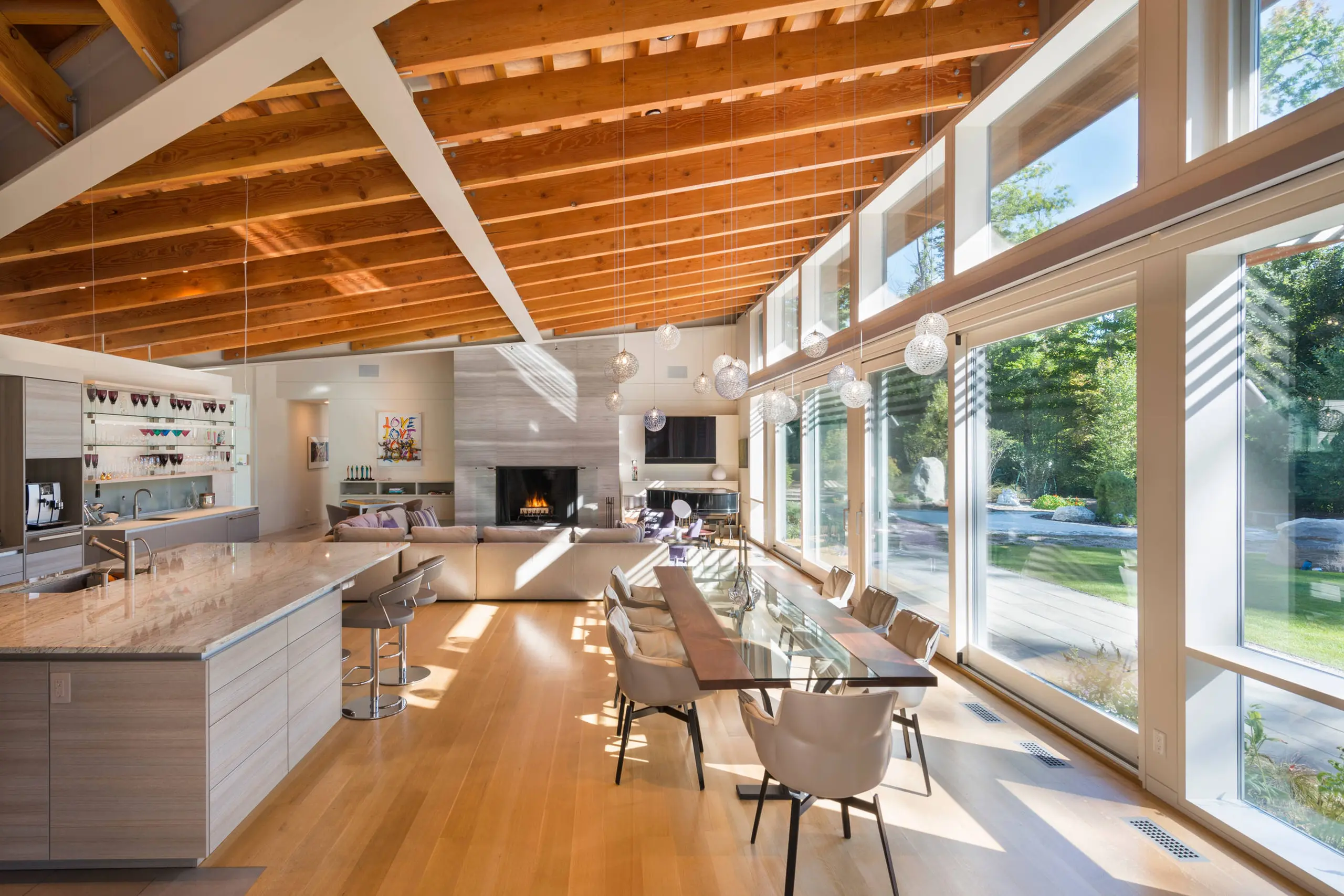 custom_colorado_live_edge_table_upscale_residential_sentient a SENTIENT contemporary designed Colorado table in maple with custom glass inset and blackened steel v shape leg detail view