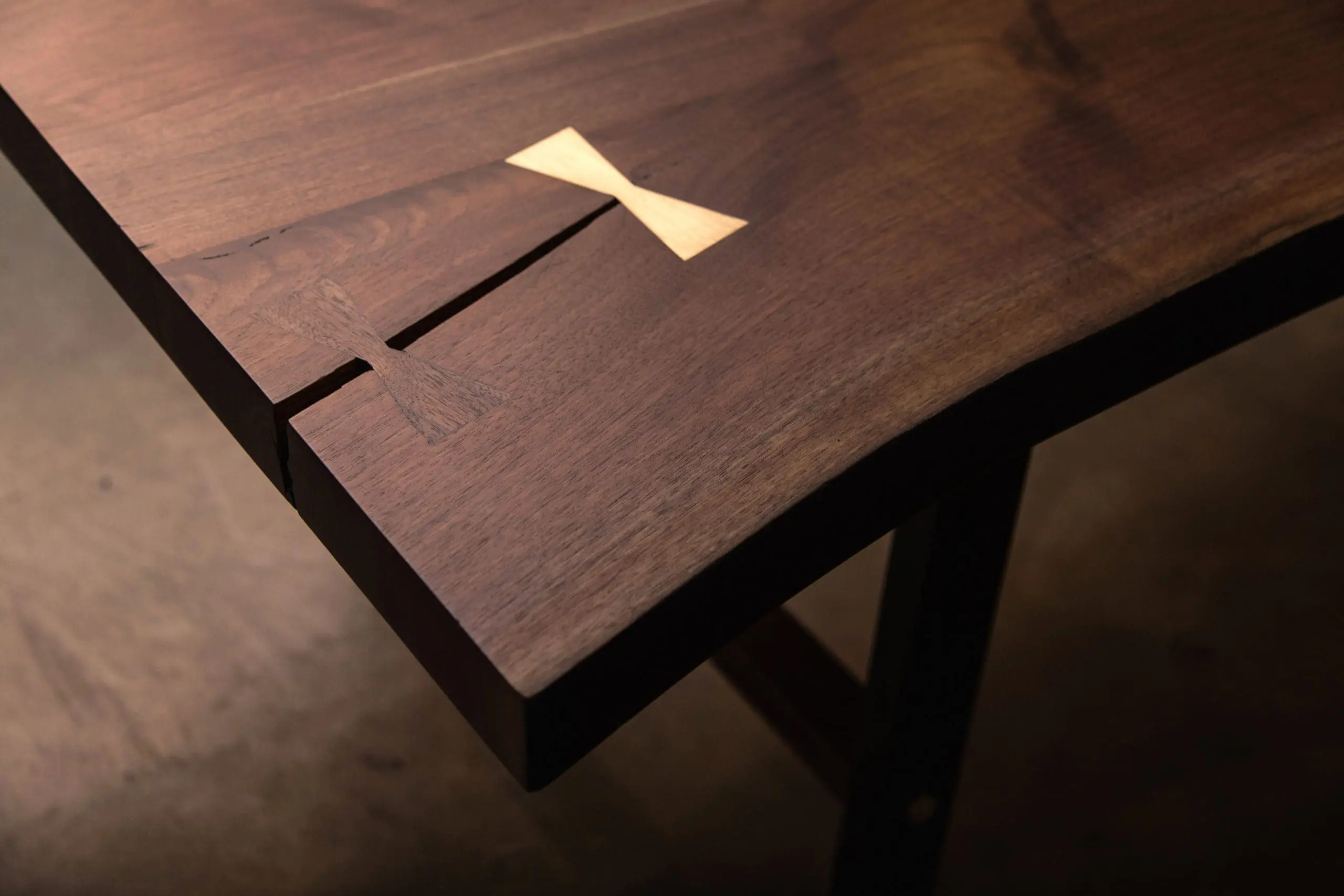 lived_edge_table_butterfly_inlays_walnut_and_brass walnut live edge table top with inlay joinery