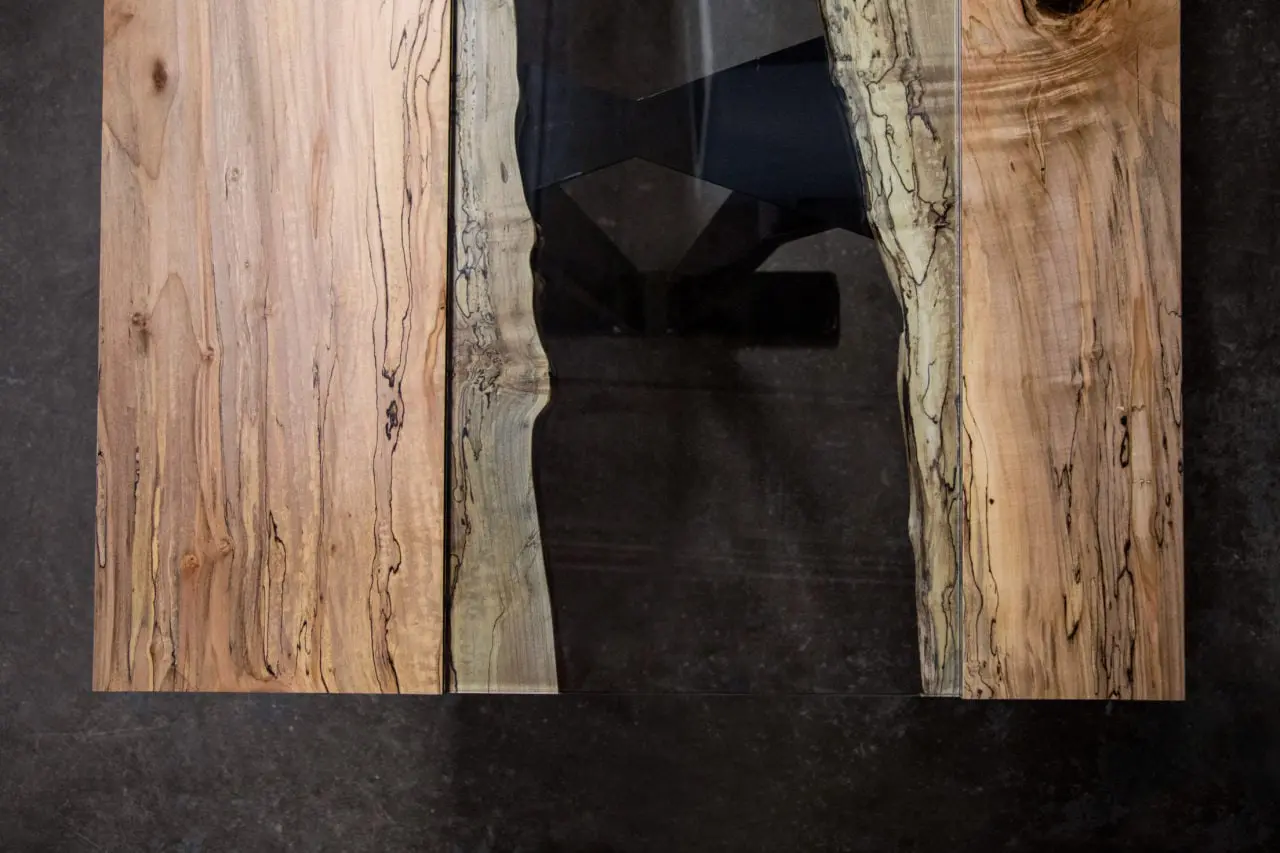 a SENTIENT contemporary designed Colorado table in ambrosia maple with custom glass inset arial view