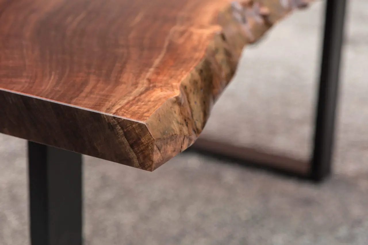 luxury computer desk - a walnut live edge custom desk corner detail with black metal frame legs