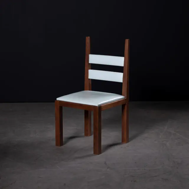 The SENTIENT DC1 Chair featuring a minimalist walnut frame and light blue leather upholstery. This timeless design blends simplicity and sophistication, ideal for modern dining or workspace settings.