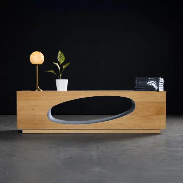 The SENTIENT Orbit Console crafted from white oak, featuring a distinctive sculptural oval cutout. A modern and minimalist design, perfect for contemporary living spaces or offices.
