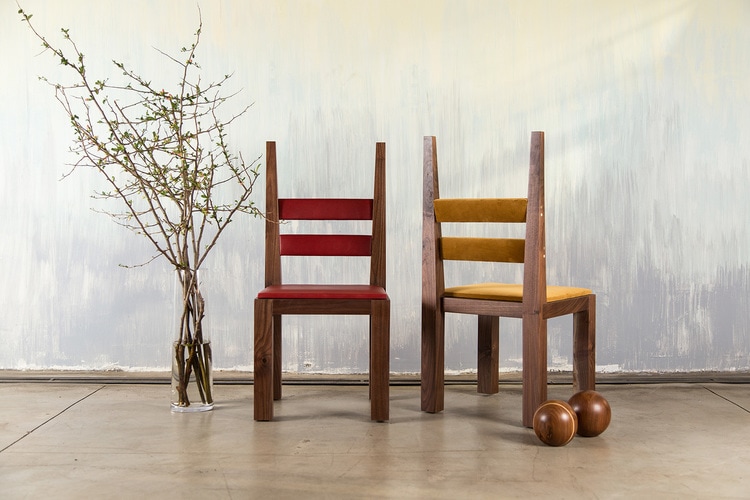 two SENTIENT luxury DC1 contemporary dining chairs in walnut one red leather and one yellow leather luxury upholstery 