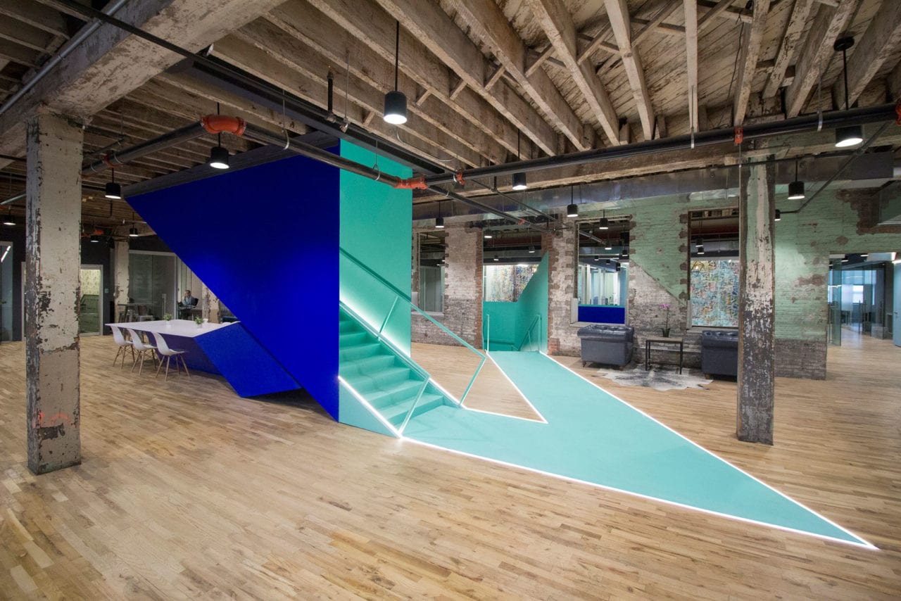 in a bond collective office SENTIENT contemporary designed custom furniture a blue wall and a green stair and angled path