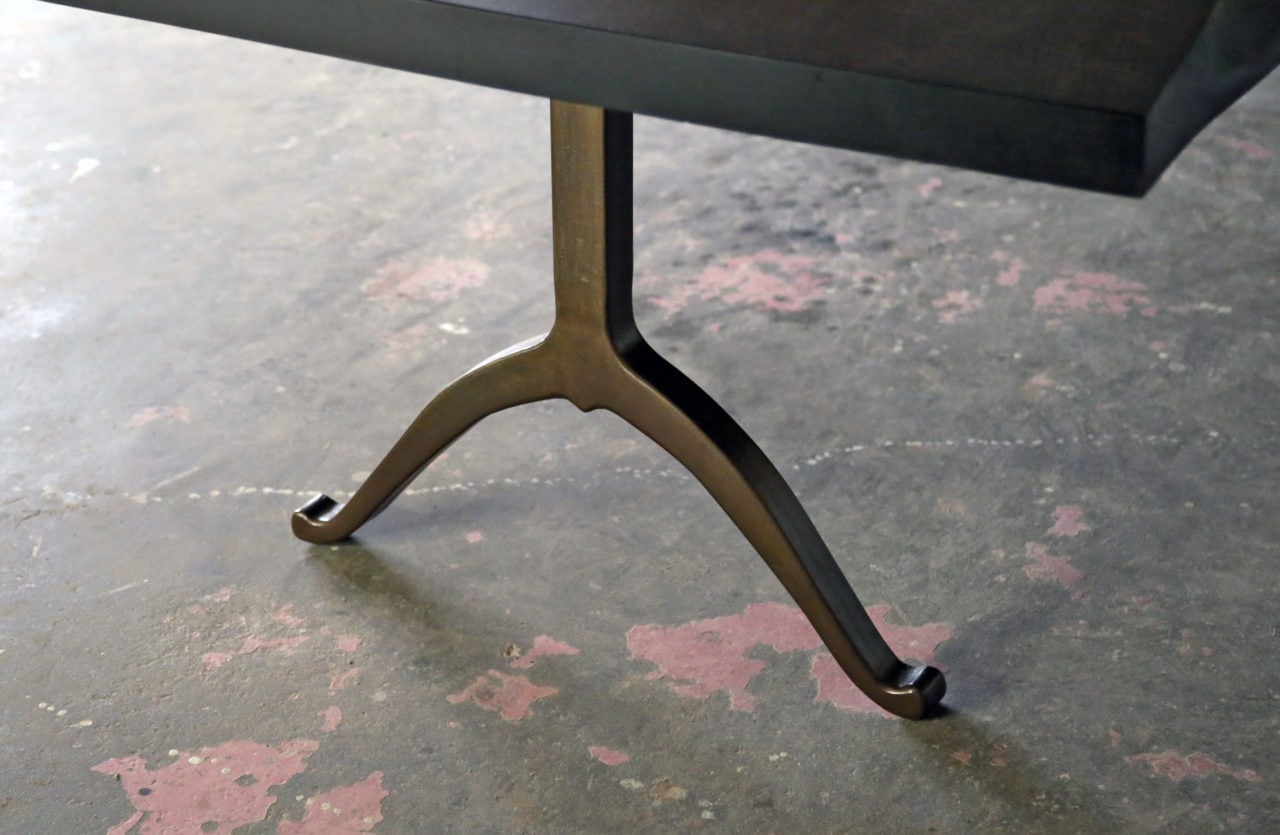 an American black walnut SENTIENT live edge luxury custom table detail with brass wishbone leg