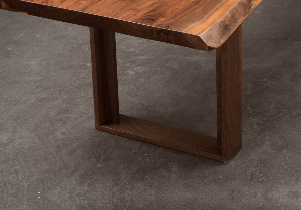 an American black walnut live edge SENTIENT contemporary custom table detail with solid wood frame leg