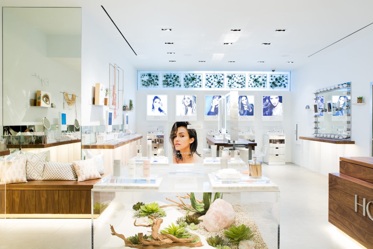 in an honest beauty retail space SENTIENT contemporary designed custom walnut counter tops and vitrine bases with beauty aids 