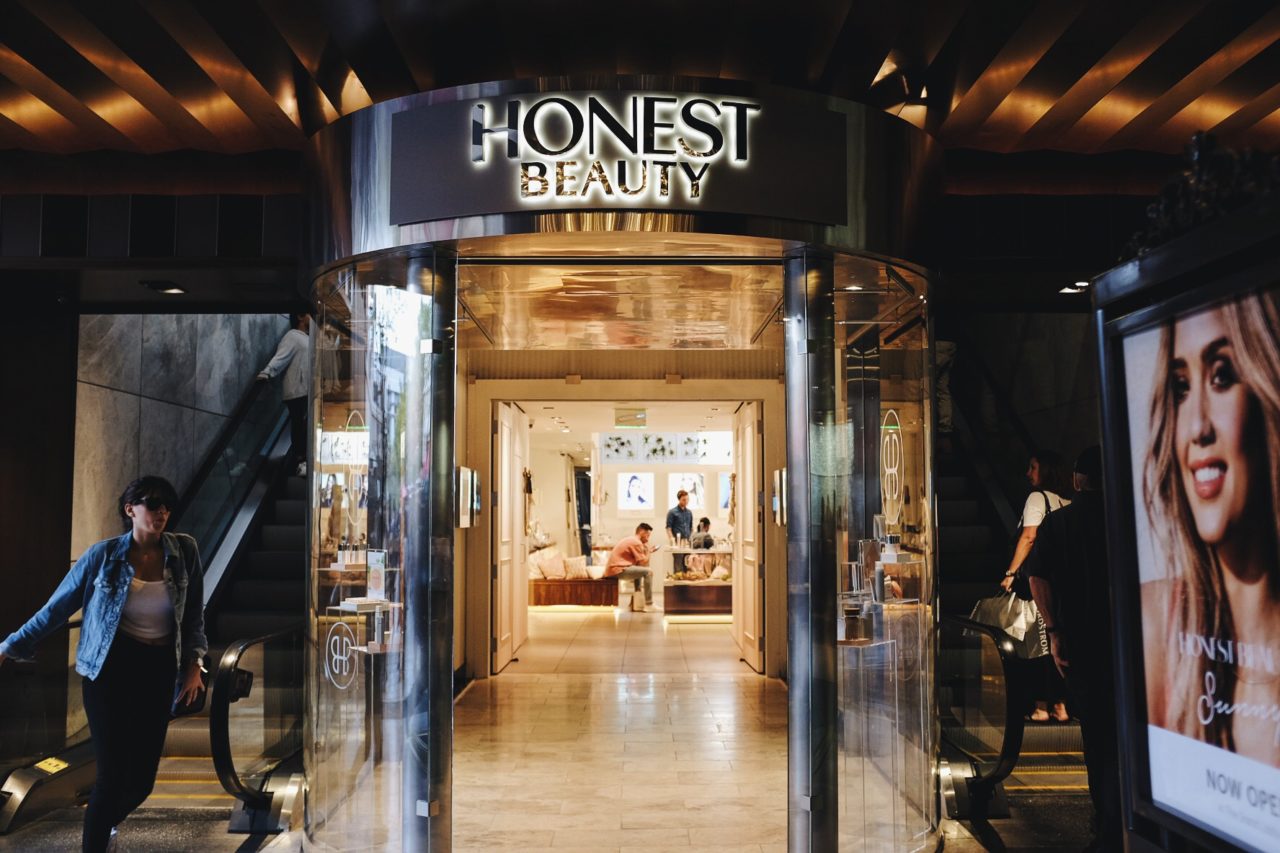 in an honest beauty retail space SENTIENT contemporary designed custom furniture viewed through front entrance of store 