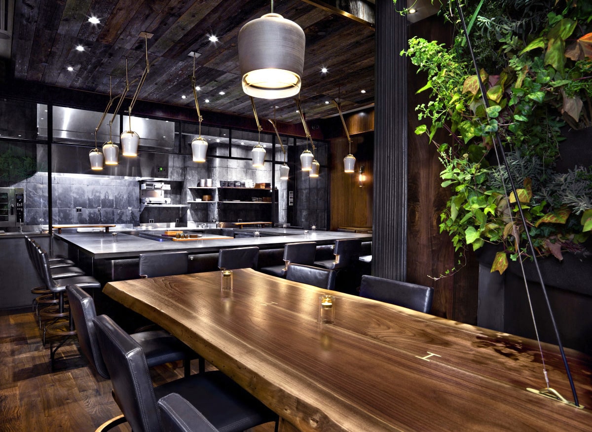 a SENTIENT contemporary designed custom walnut luxury solid live edge table in altera restaurant 