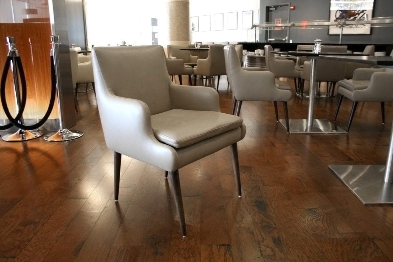 a group of custom SENTIENT contemporary designed luxury leather chairs and wood tables in British airways lounge