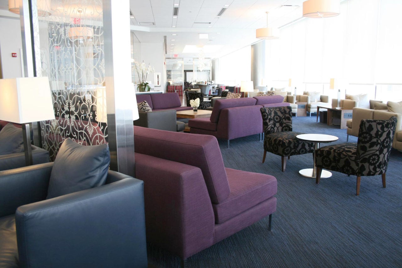 a group of custom SENTIENT contemporary designed luxury upholstered chairs and wood tables in British airways lounge 