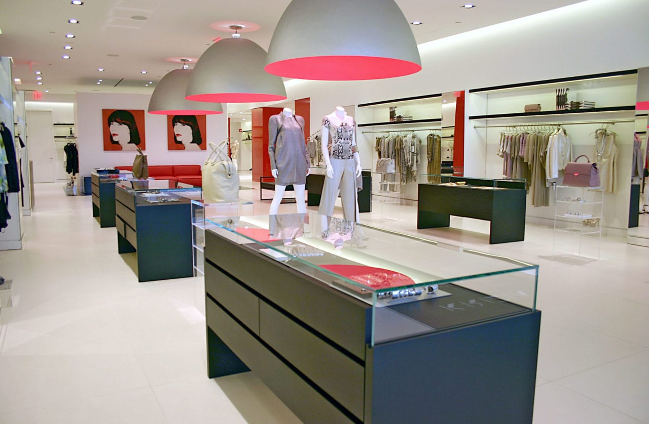 custom SENTIENT contemporary designed furniture in a Kritzia retail space with Andy Warhol art and pink and red accents