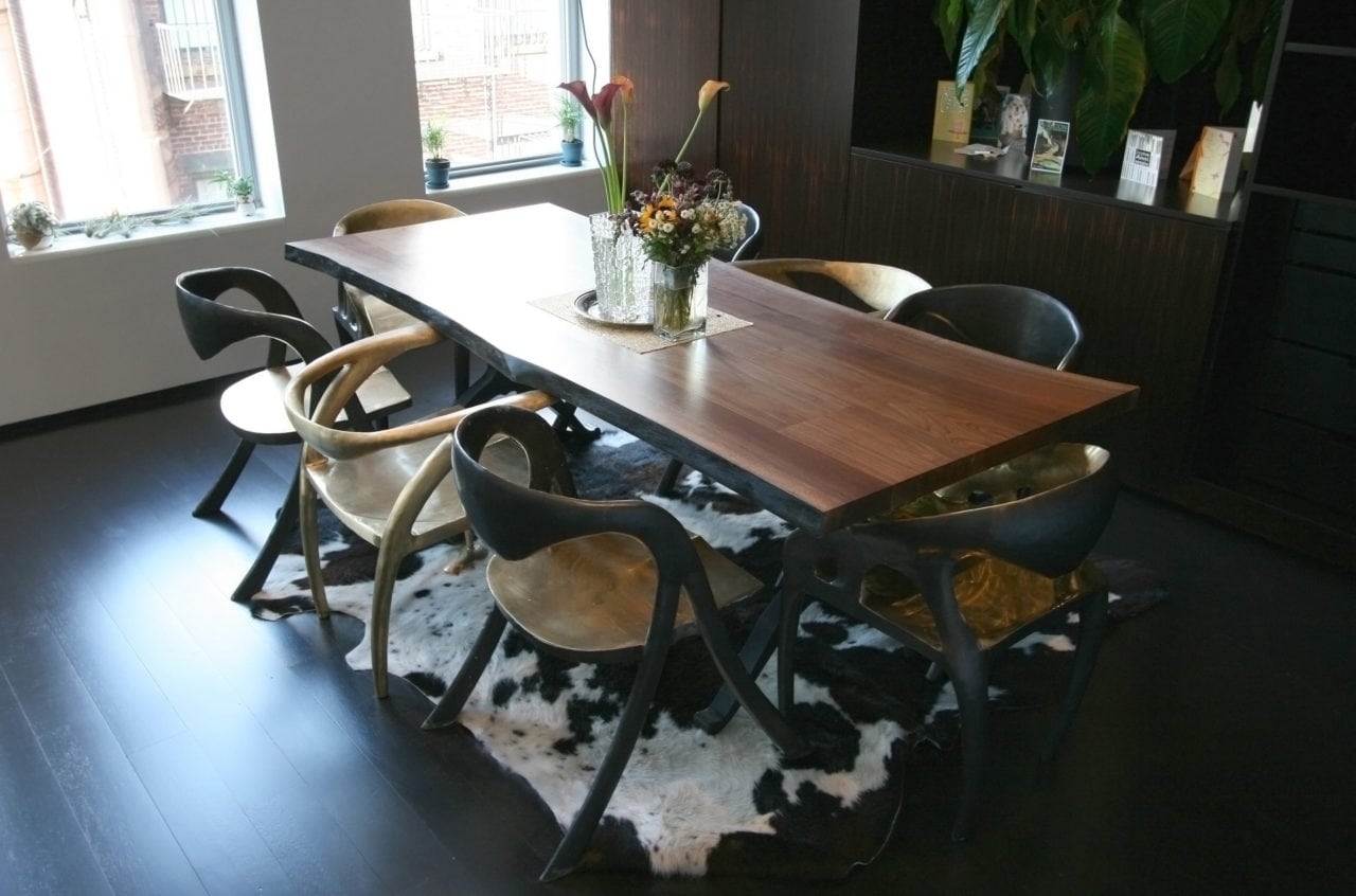 a custom SENTIENT contemporary designed live edge walnut table in a luxury designed dining room