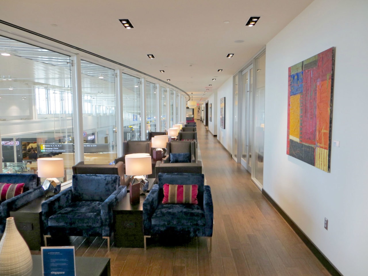 a long line of SENTIENT contemporary designed custom upholstered luxury chairs and tables in British airways Washington lounge