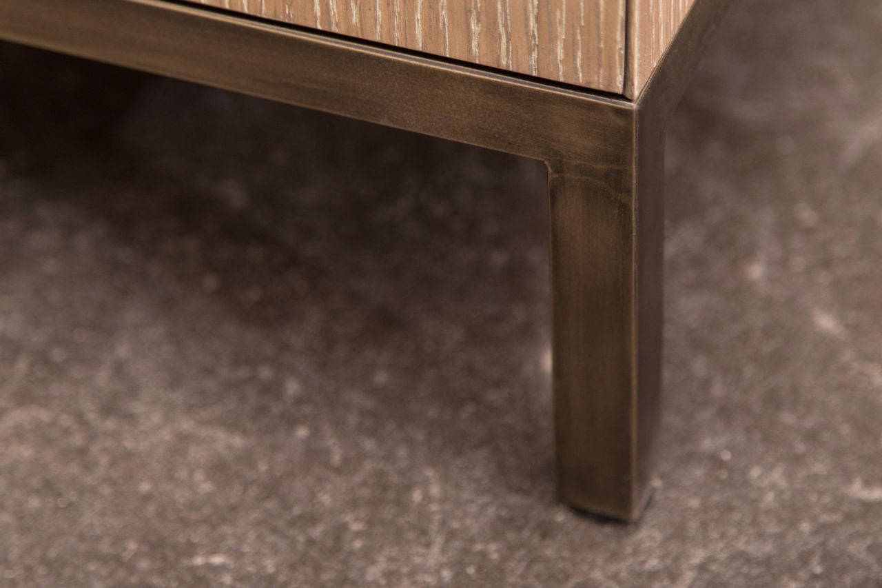 a detail view of a SENTIENT contemporary design custom wood cabinet brass let