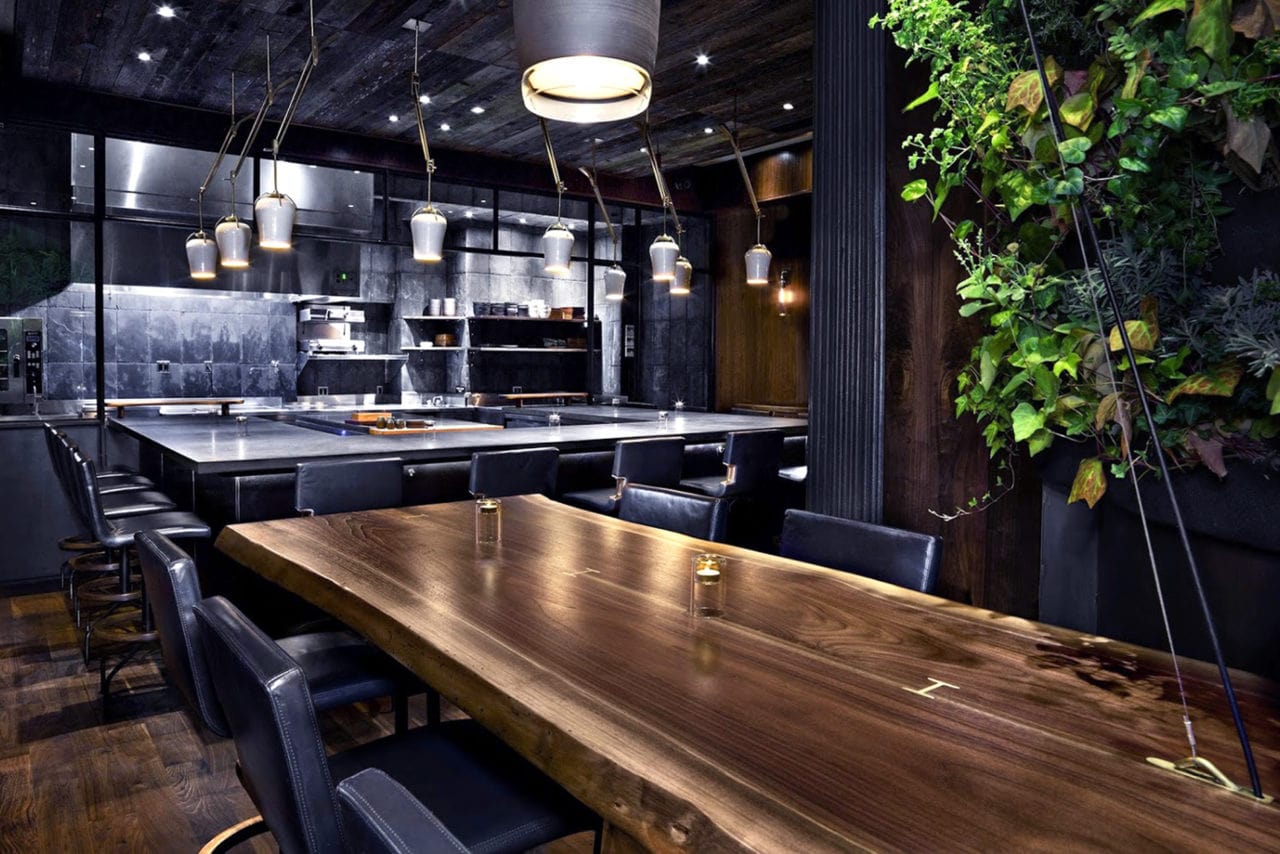 a custom SENTIENT contemporary designed walnut live edge table in luxury atera restaurant 