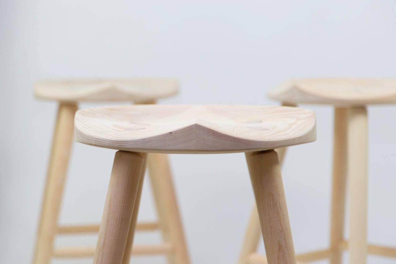 three custom SENTIENT contemporary designed stools in light maple wood two in the back on in front