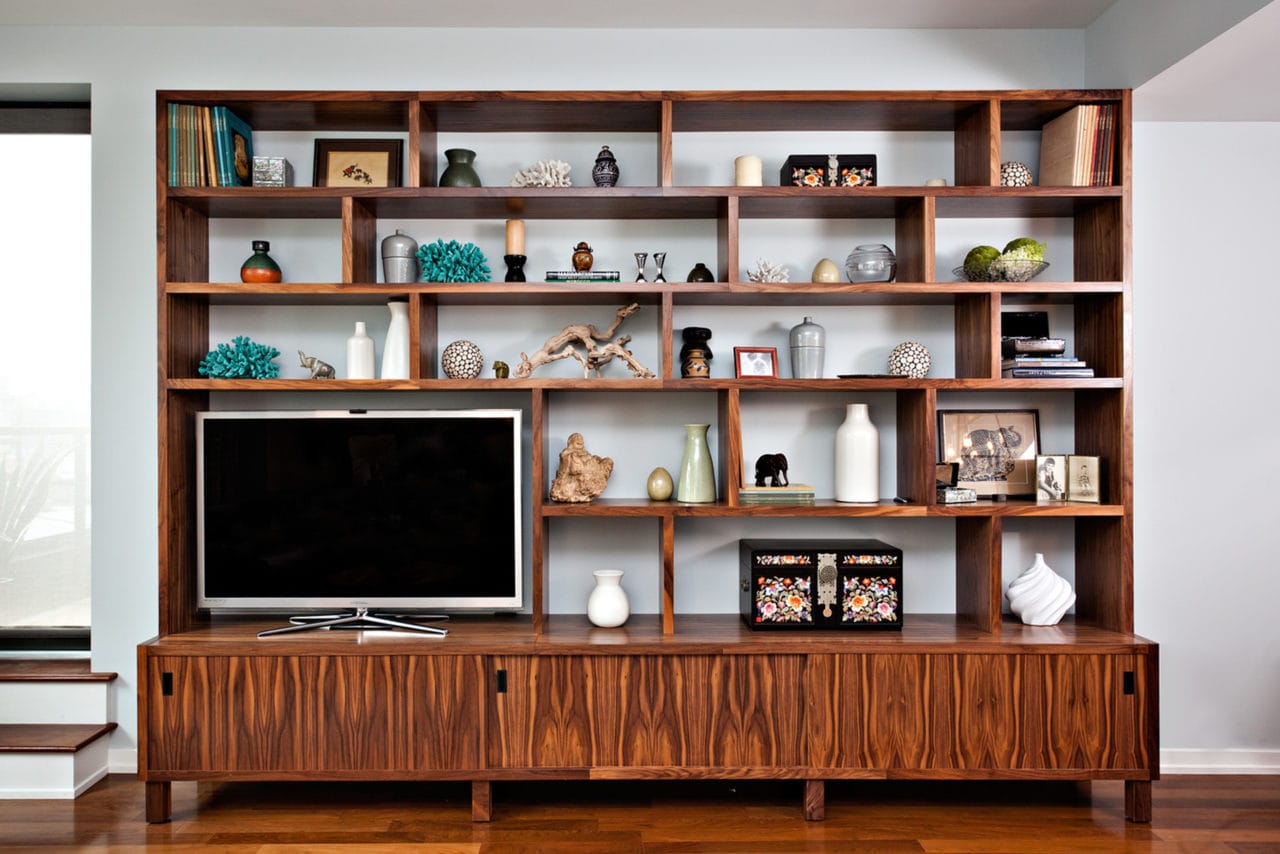 a custom high-end SENTIENT contemporary designed wood cubicle luxury bookcase with tv and books