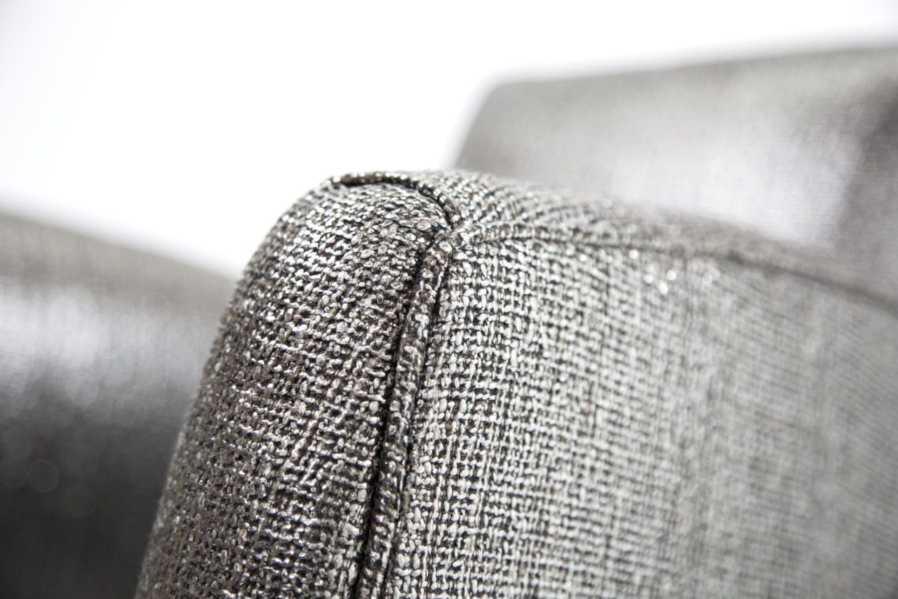 arm detail of SENTIENT contemporary designed luxury upholstered custom chair in silver color for British airways 