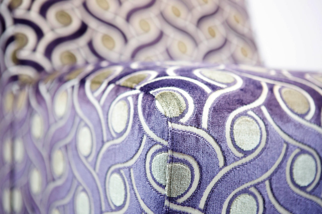 a custom upholstered SENTIENT contemporary designed arm chair detail with luxury purple pattern
