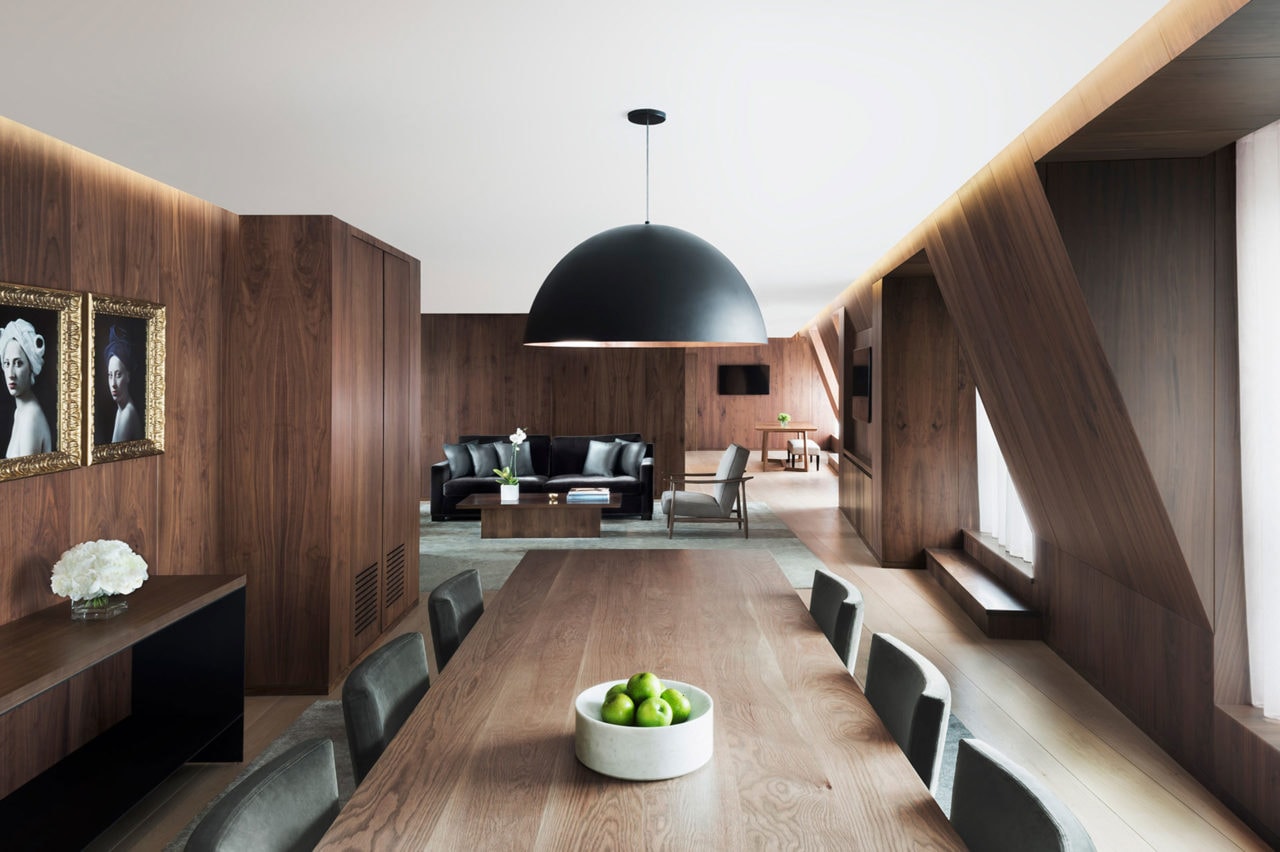 a walnut custom SENTIENT contemporary designed dinning table in walnut clad London edition hotel penthouse