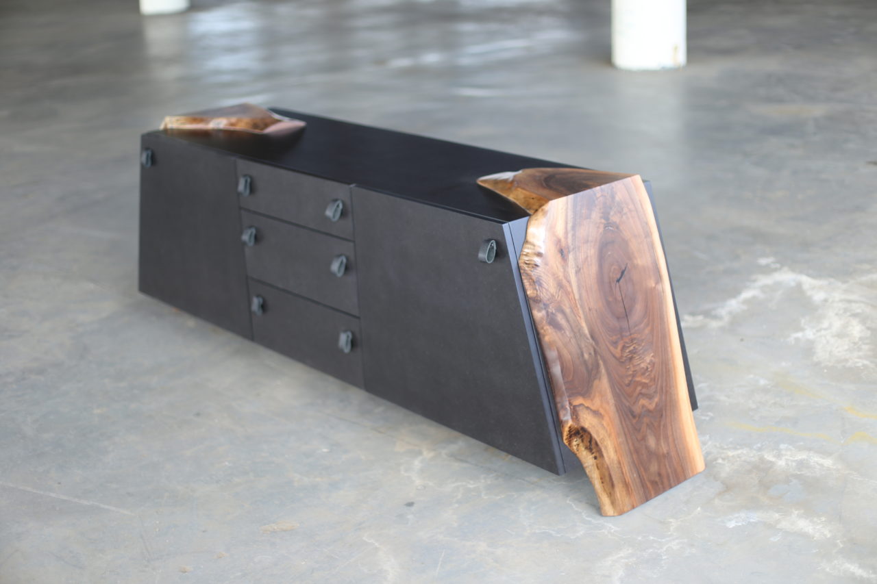a custom SENTIENT contemporary designed luxor console table with walnut live edge wood ends and matte black outer shell