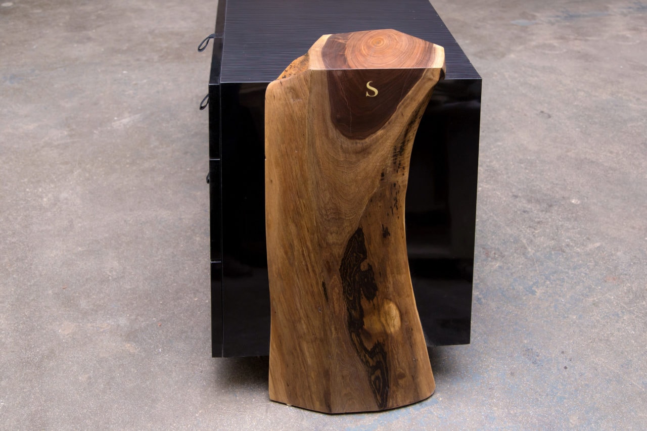 a custom SENTIENT contemporary luxor console table with walnut live edge wood ends and matte black outer shell end view