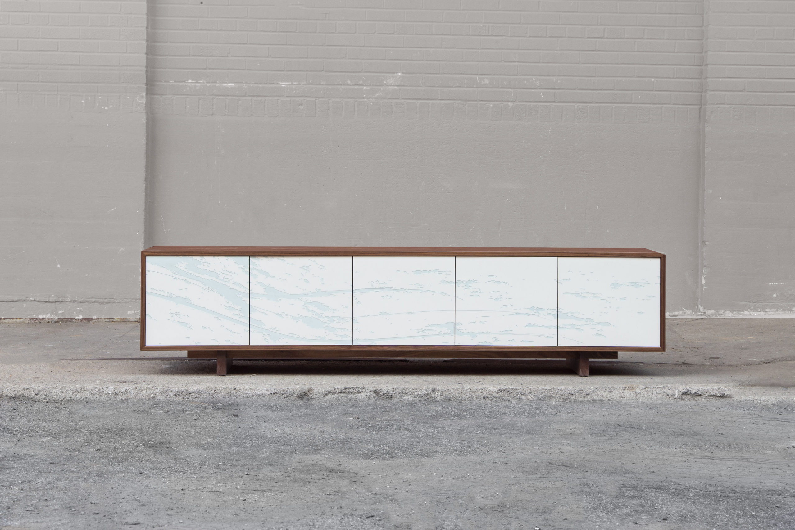 a custom SENTIENT contemporary designed neosho credenza dresser with walnut wood shell and photo etched fronts