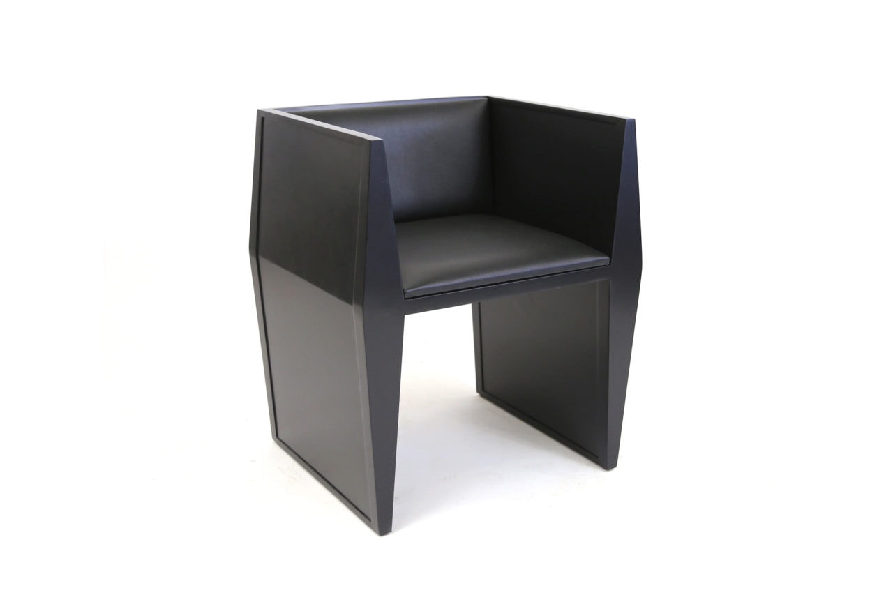 a contemporary designed SENTIENT sapience arm chair in walnut with stain luxury upholstered black leather custom seat