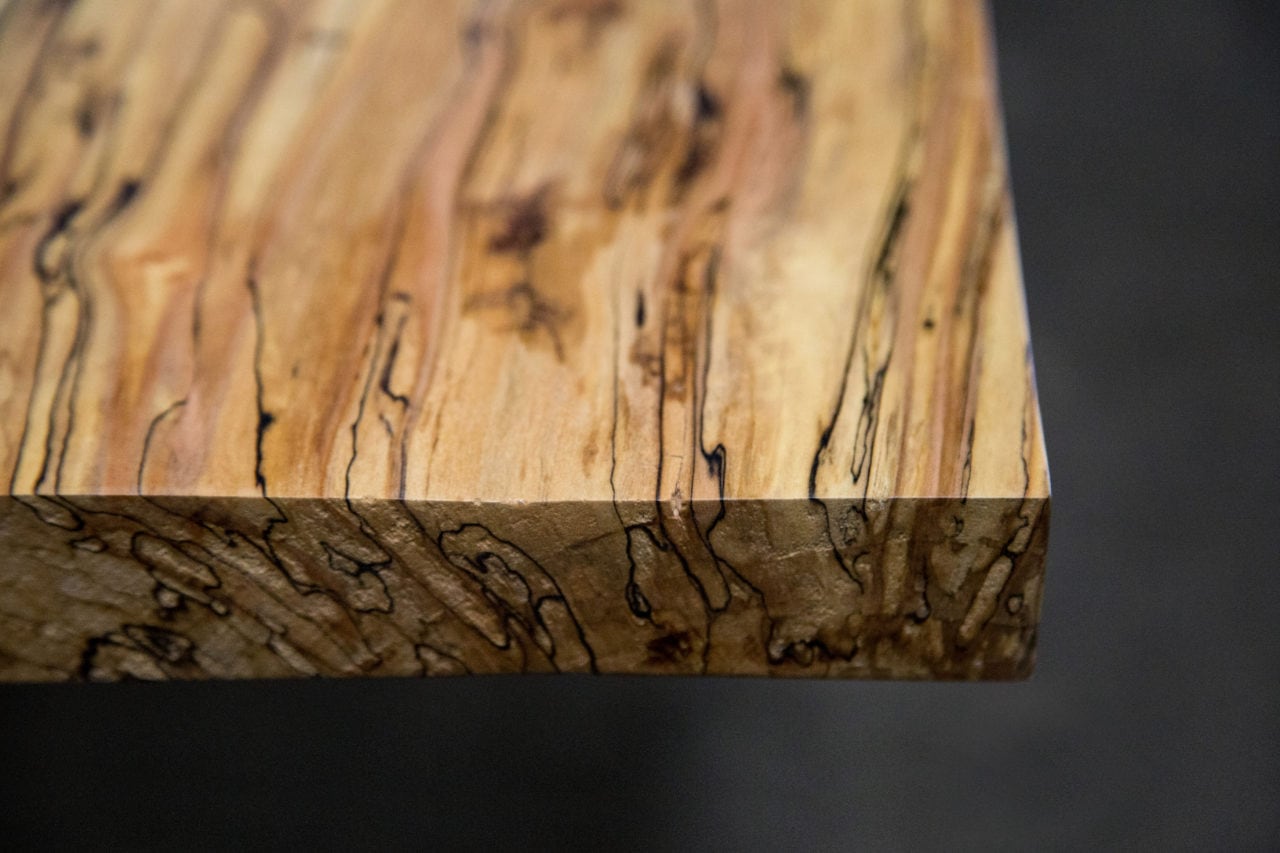 a SENTIENT contemporary designed Colorado custom table in ambrosia maple top corner detail view 
