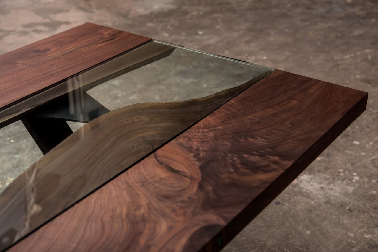 an arial detail view of a SENTIENT contemporary designed Colorado custom table in luxury walnut with glass inset down the middle
