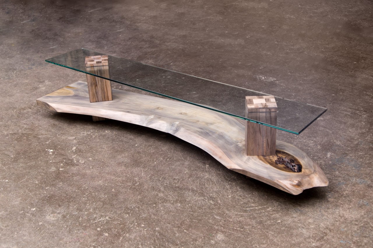 a SENTIENT contemporary designed foothills console in custom driftwood maple and smoked glass top angled view