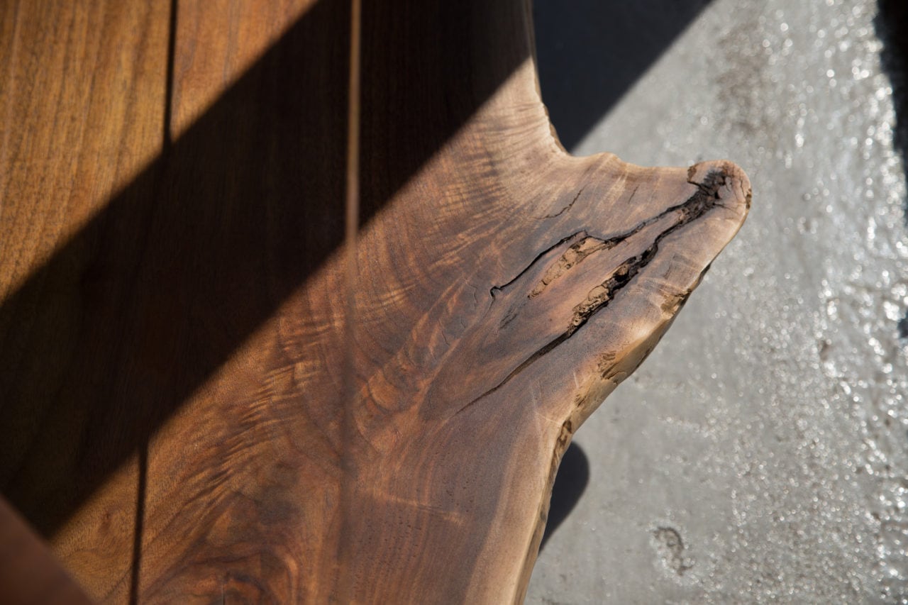 a contemporary walnut wood live edge SENTIENT foothills console tv stand detail in shadow