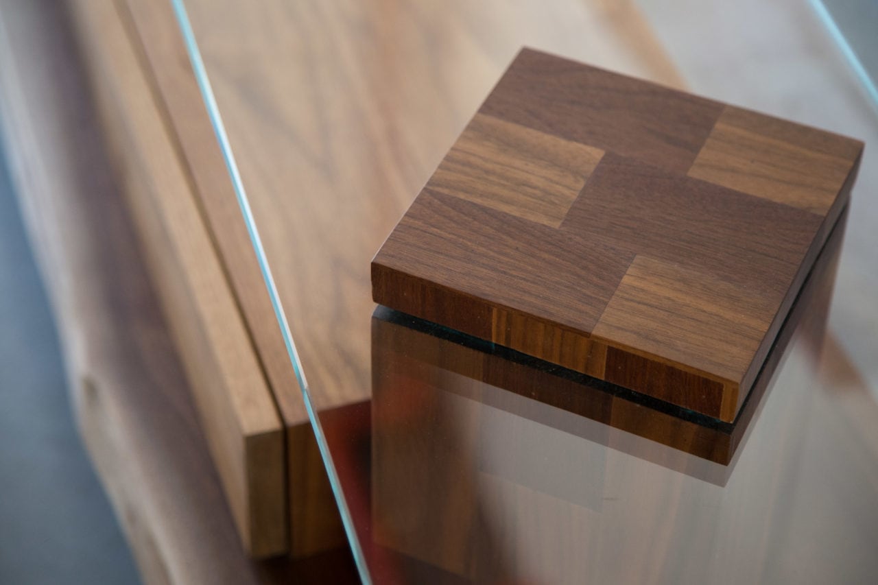 a SENTIENT contemporary designed foothills console in custom walnut and glass top with storage box detail view