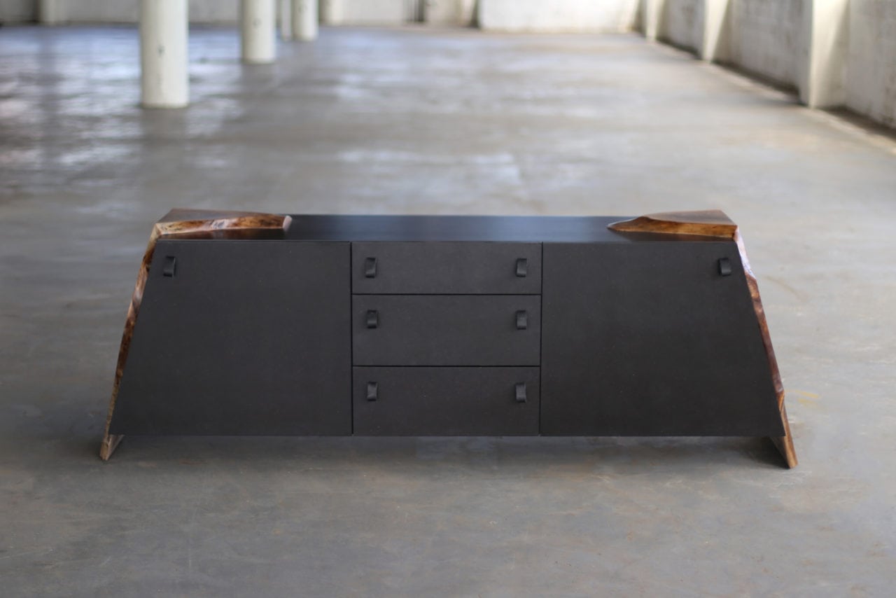 a custom SENTIENT contemporary designed luxor console table with walnut live edge wood ends and matte black outer shell  