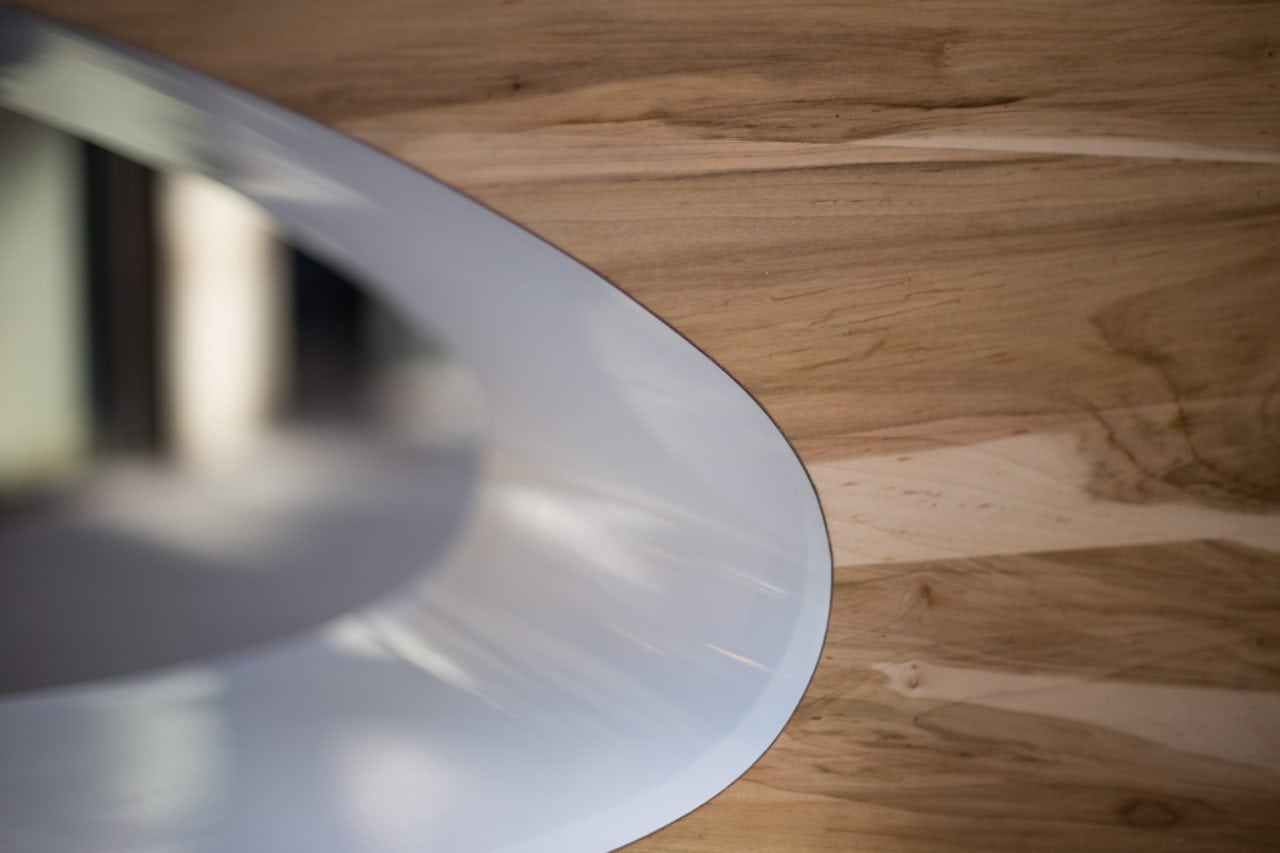 a custom SENTIENT contemporary maple Orbit coffee table detail with white oval cutout
