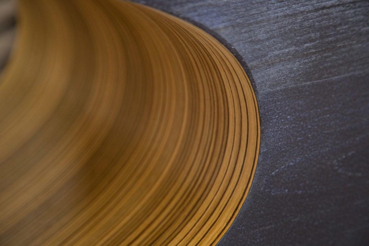 a SENTIENT contemporary custom dark stained Orbit coffee table detail with yellow oval cutout detail view