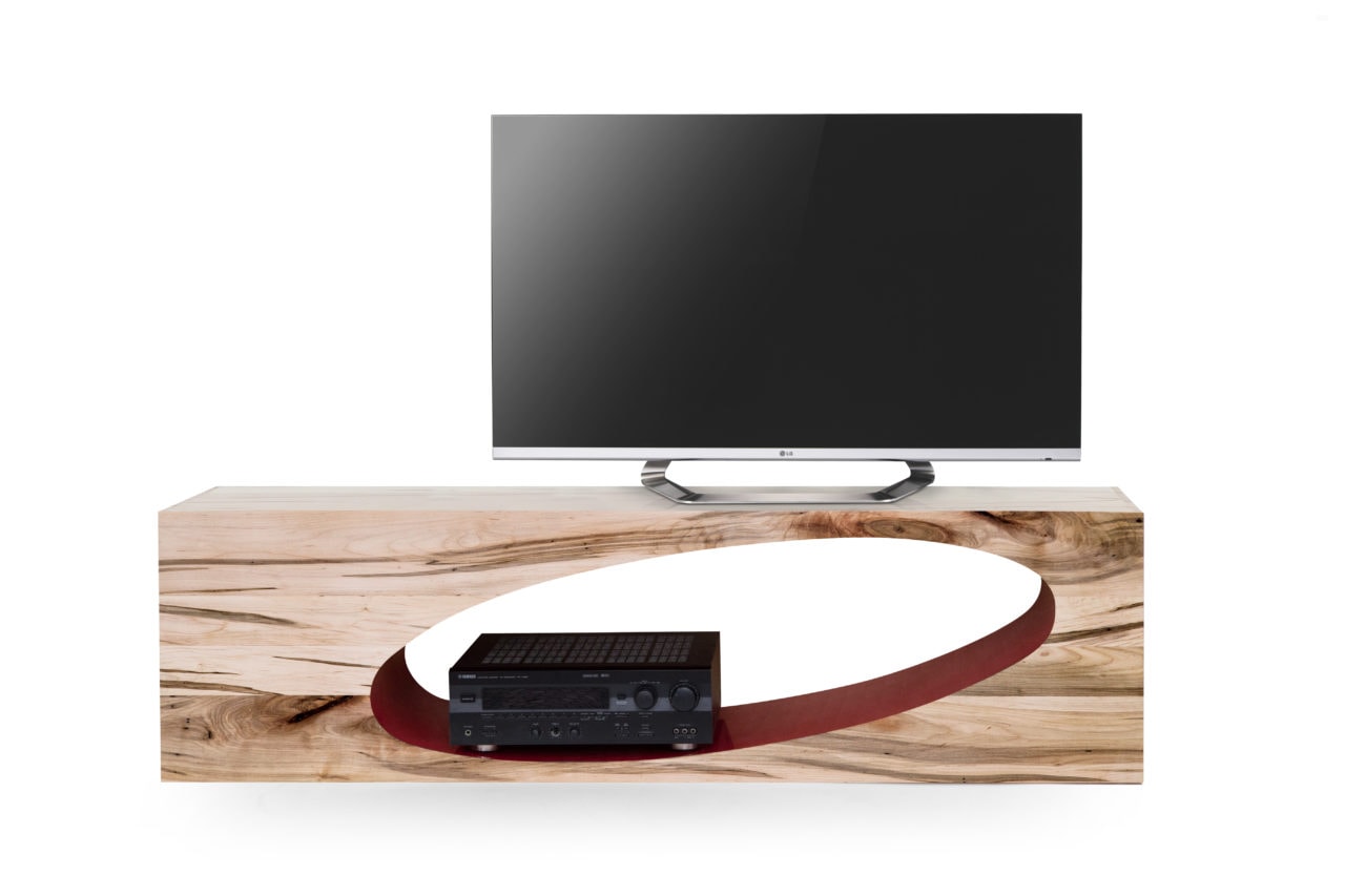 TV atop a long SENTIENT contemporary Orbit coffee table with oval cutout in custom light maple 