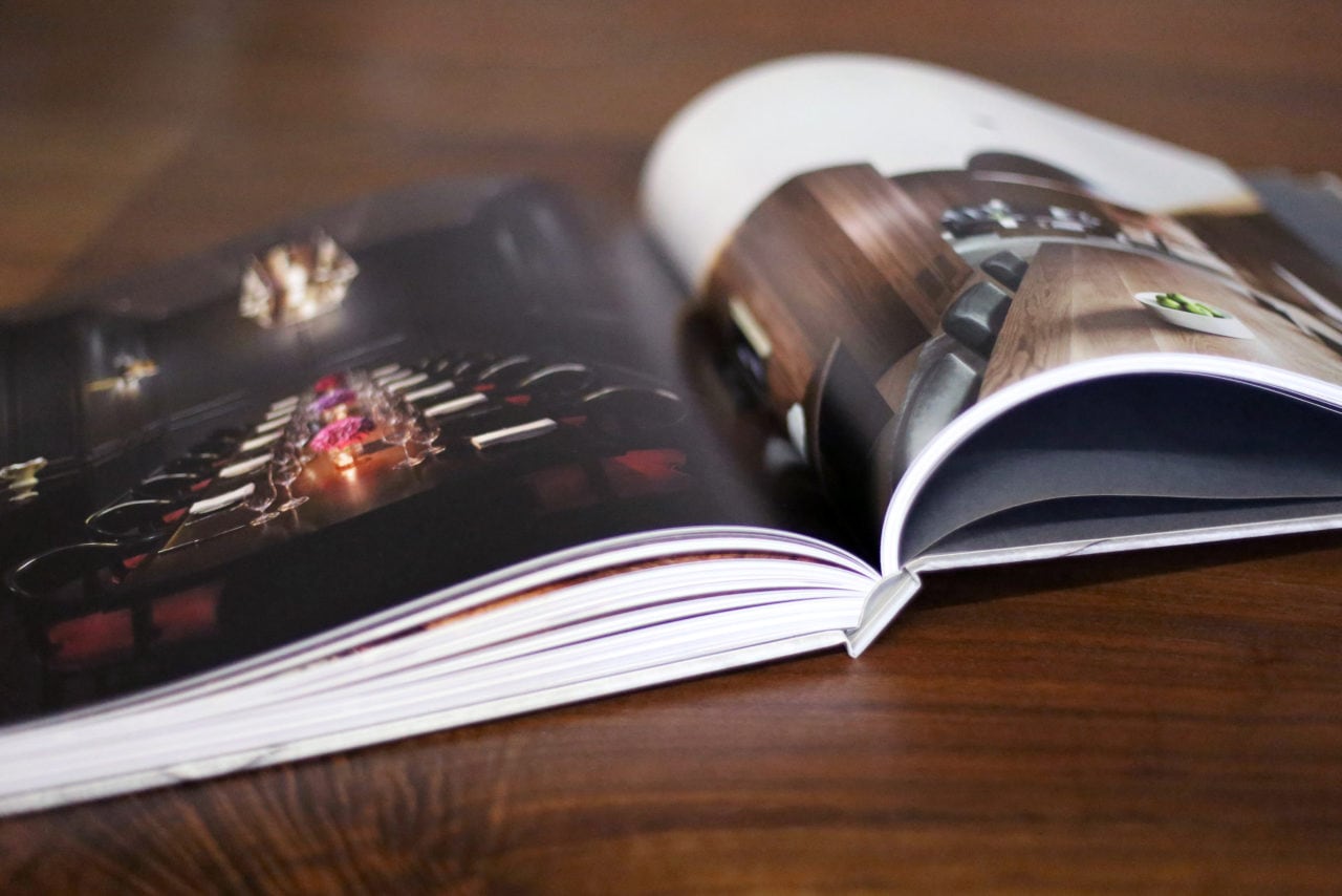 an open SENTIENT contemporary designed catalog luxury design book