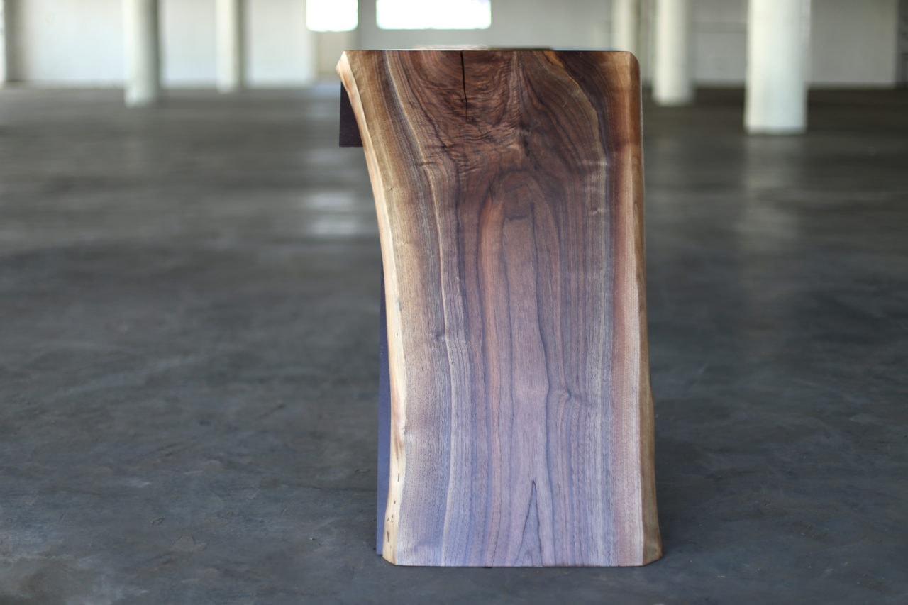 a SENTIENT contemporary designed time when custom console end view of live edge detail in open loft