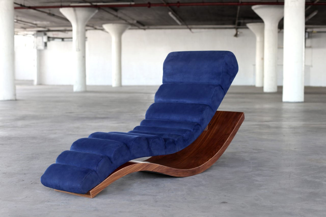 a SENTIENT contemporary designed wave lounge chair in luxury blue velvet with custom walnut base 