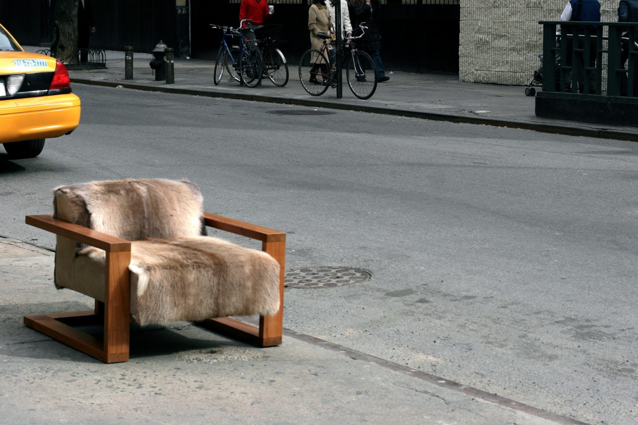 a SENTIENT contemporary designed caribou custom chair in walnut and luxury fur photographed on street