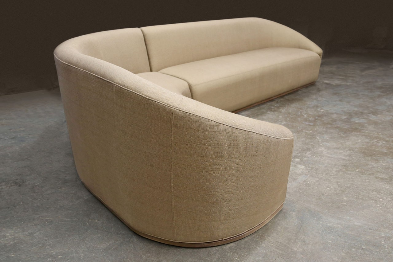 a upholstered SENTIENT baashe contemporary curved sectional sofa in luxury natural warm toned fabric 