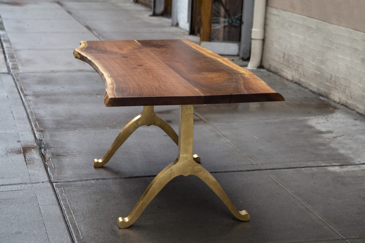 a custom SENTIENT contemporary designed live edge desk in luxury walnut with brass wishbone legs