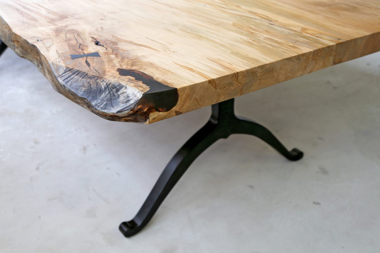 a SENTIENT contemporary designed custom maple live edge table corner with black wishbone legs