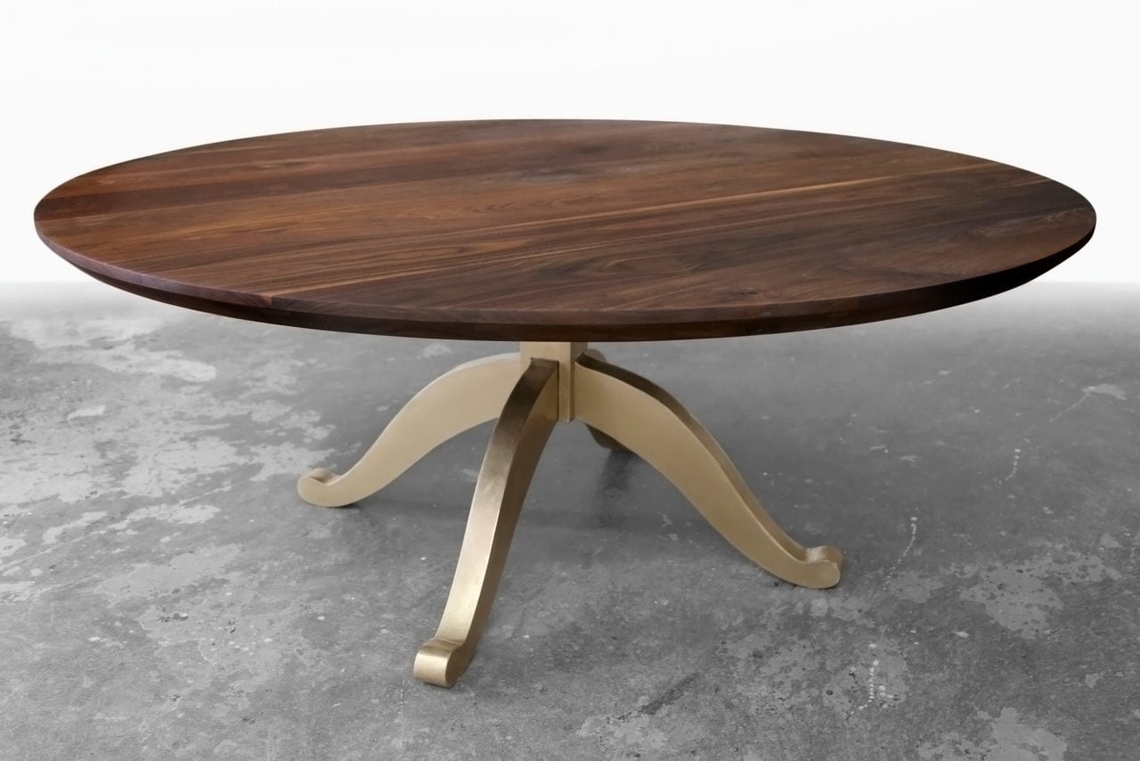 a Sentient round luxury American black walnut contemporary table with brushed brass 
