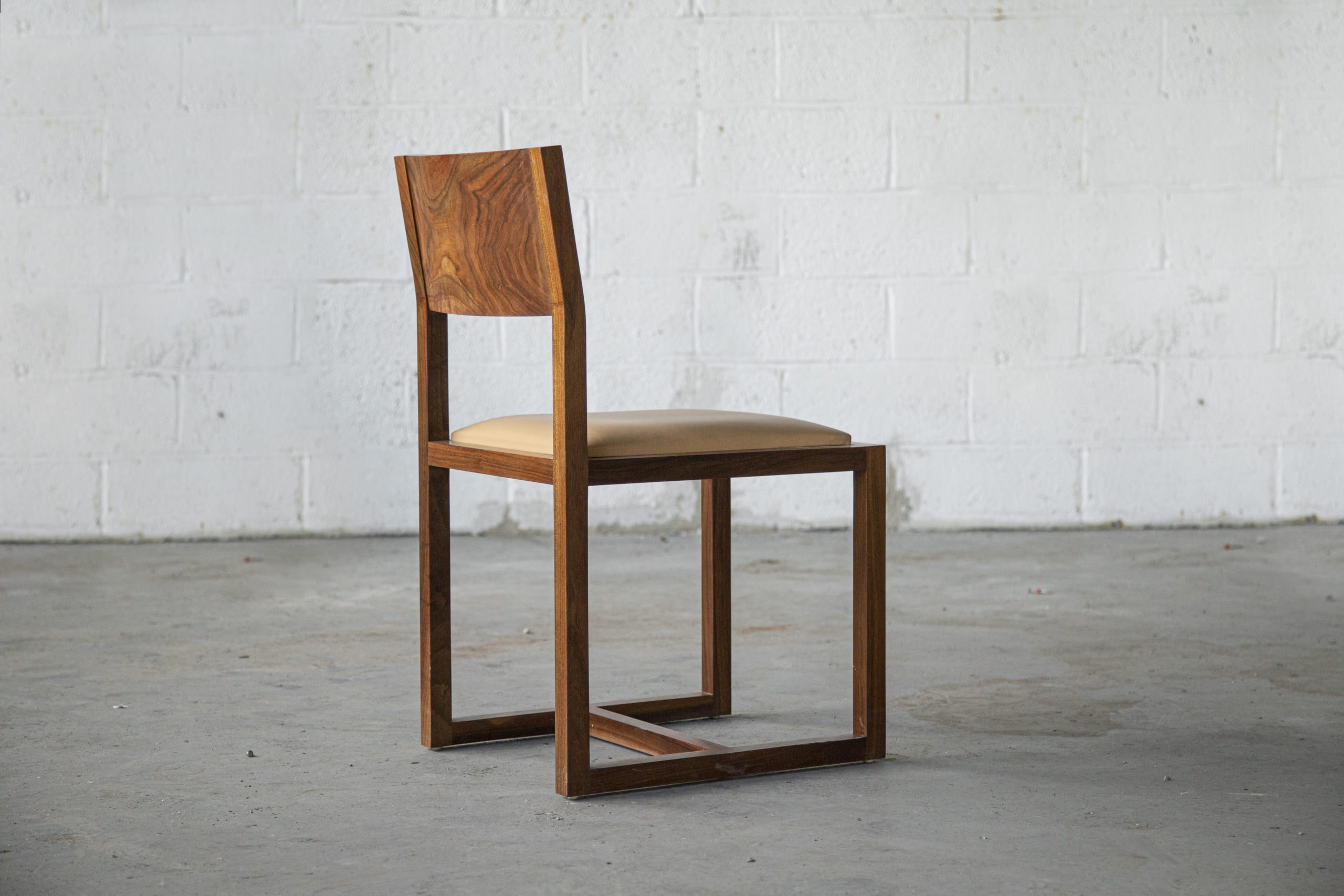 SENTIENT contemporary designed St Lawrence dining chair in walnut with custom leather seat side view facing right