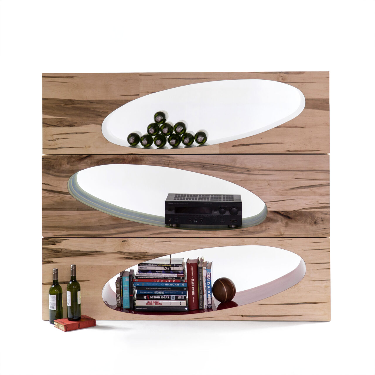 SENTIENT’s Orbit Console presents a creative twist on traditional shelving, with smooth, elliptical cutouts set against a richly textured wooden backdrop. This artistic wall-mounted unit serves both as a functional space for storage and a striking visual element for any contemporary living space.