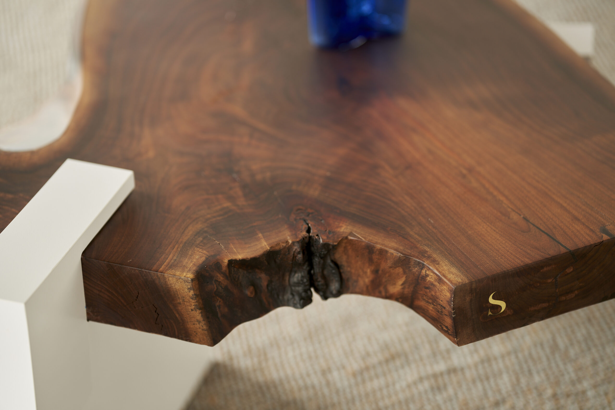 Top angle view of the SENTIENT Sylvan live edge coffee table, emphasizing the natural edge and organic design of the black walnut surface.