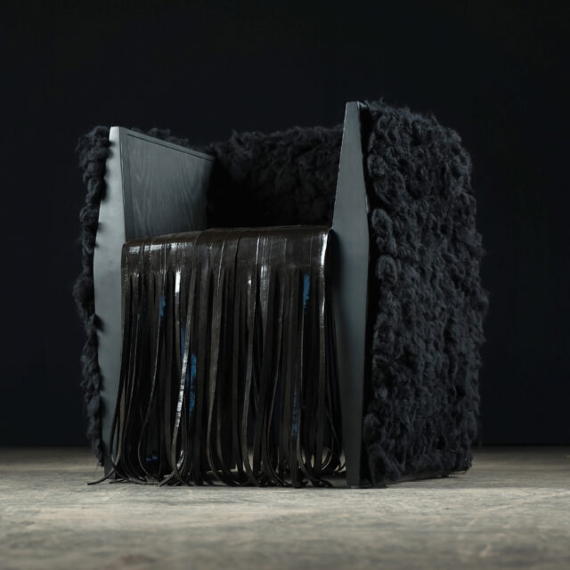 Low angle side view of the SENTIENT Sapience Chair designed in collaboration with Le Studio Anthost, emphasizing the unique combination of materials and textures.